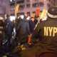 An NYPD officer on a motorbike keeps track of anti-police-brutality protesters as they march through the Upper East Side in New York City Dec. 23, 2014.
Michael Graae/Getty Images